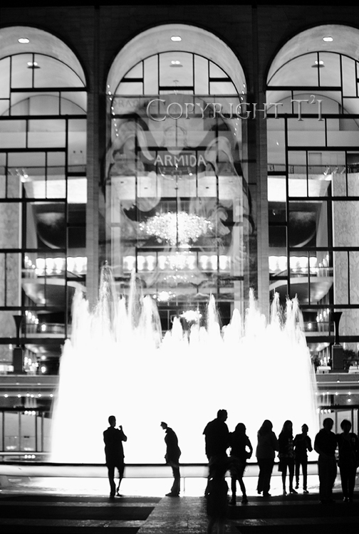Lincoln Center New York City Manhattan NYC with visitors around the fountain in sihouetted